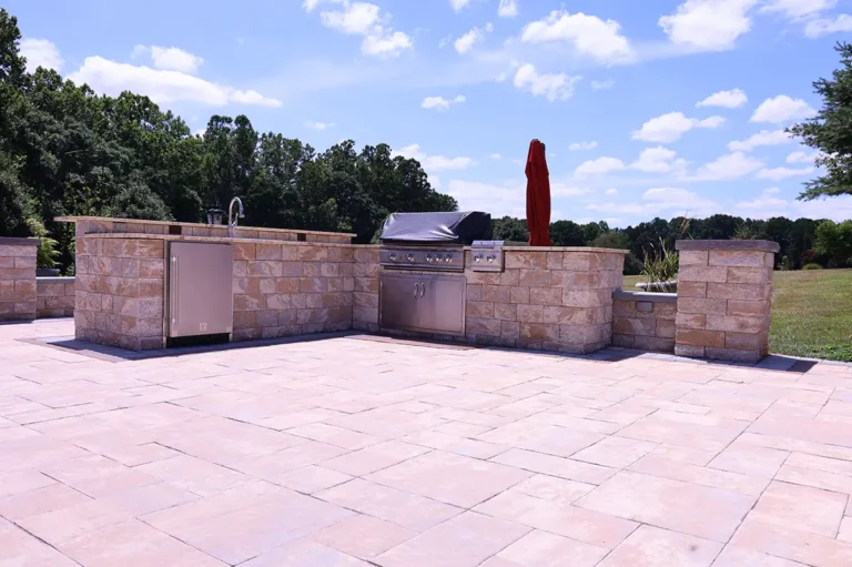 Large paver patio with outdoor kitchen and umbrella — Silver Spring, MD