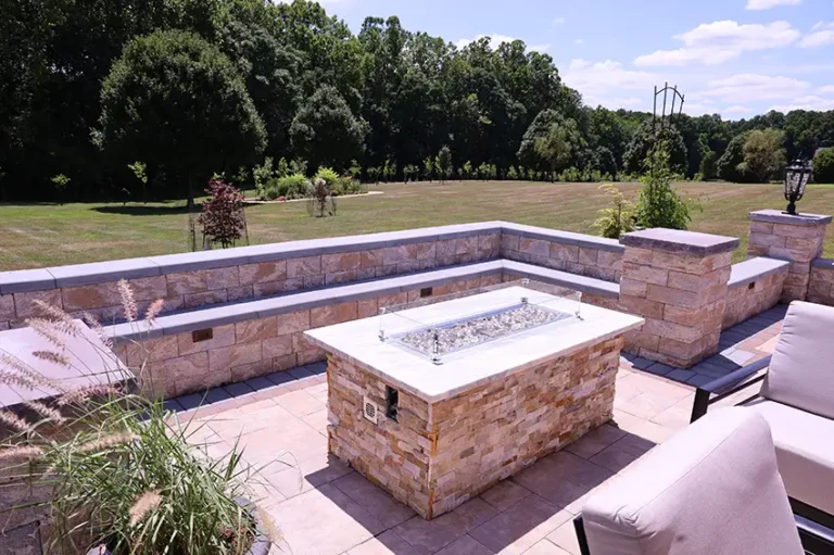 Cozy stone fire pit integrated into custom patio — Silver Spring, MD