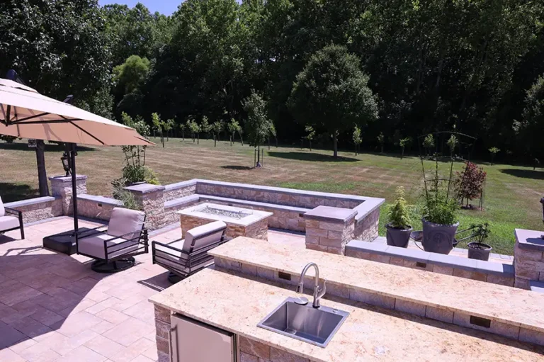 Custom outdoor kitchen with sink and stone counters — Silver Spring, MD