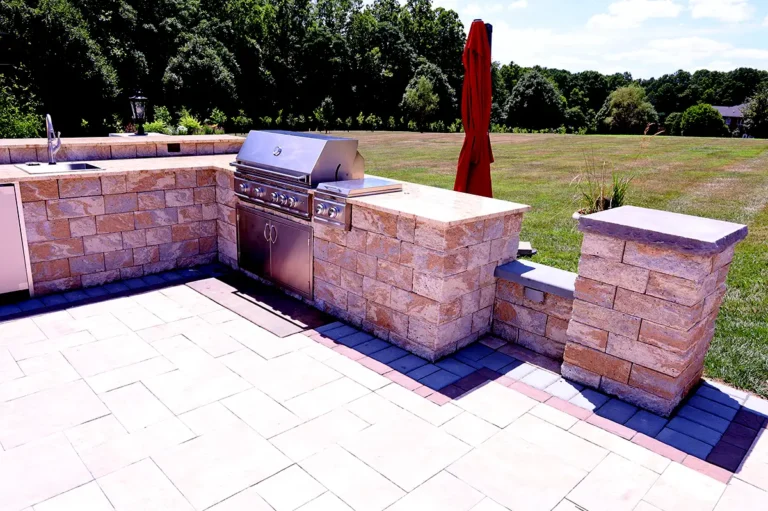 Spacious backyard patio with built-in kitchen and seating in Silver Spring, MD