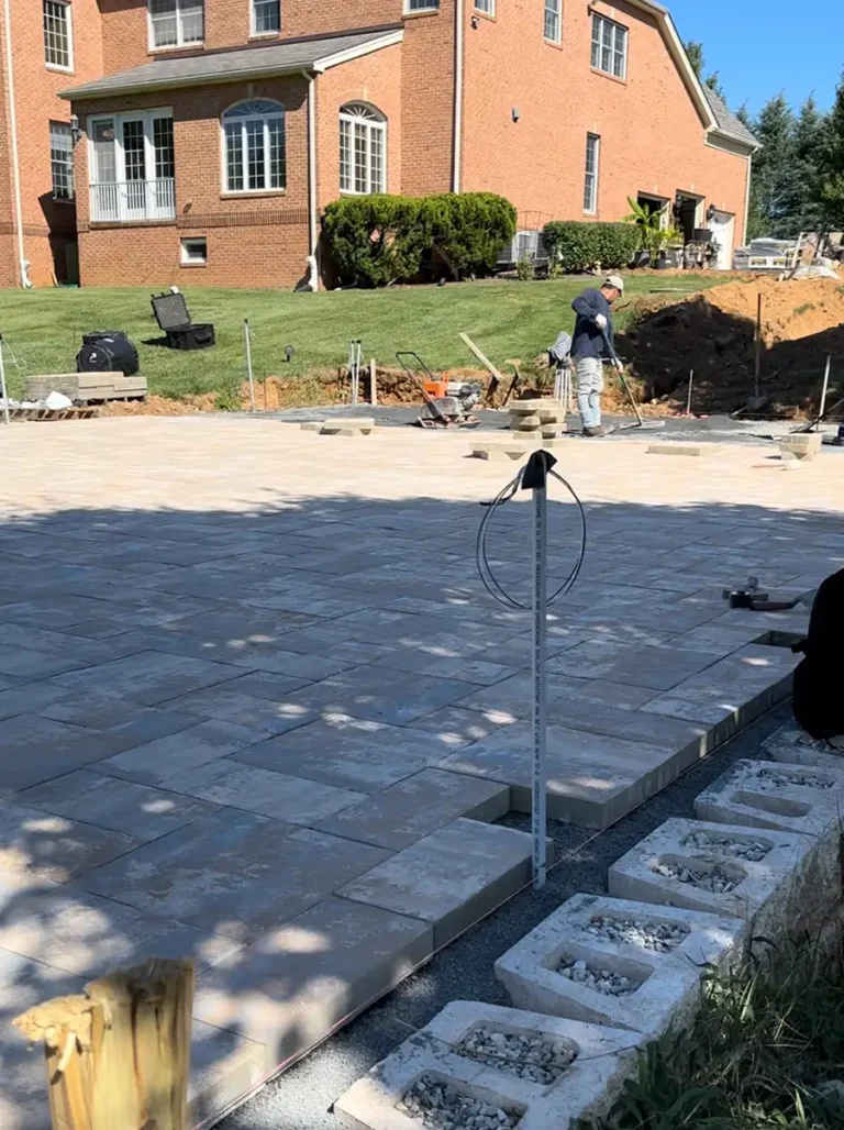 Paver patio installation in progress with lighting setup — Outdoor Hardscape in Silver Spring, MD